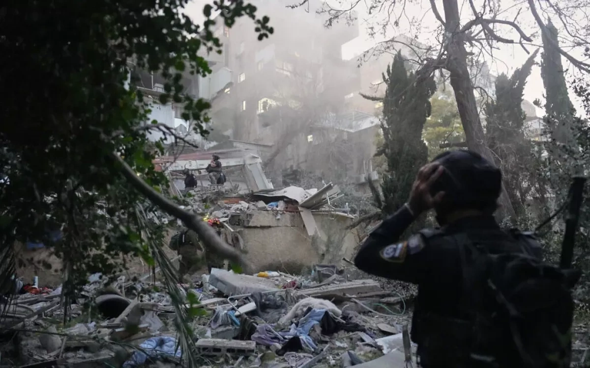 Nine injured, several feared trapped after rocket hits Haifa